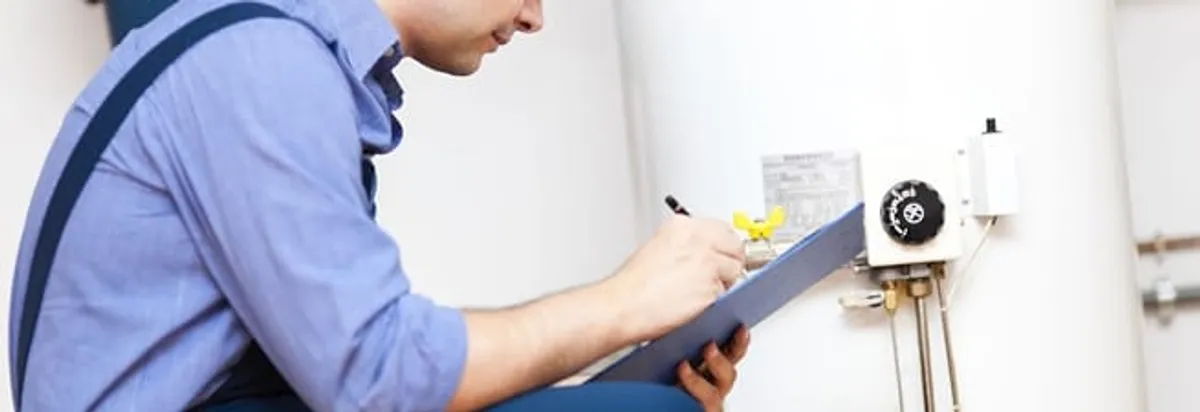 Water heater repair technician inspecting the unit and recording service notes in Charleston, SC
